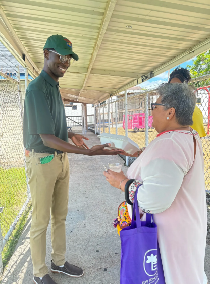 Volunteer distributing assistance to a community member